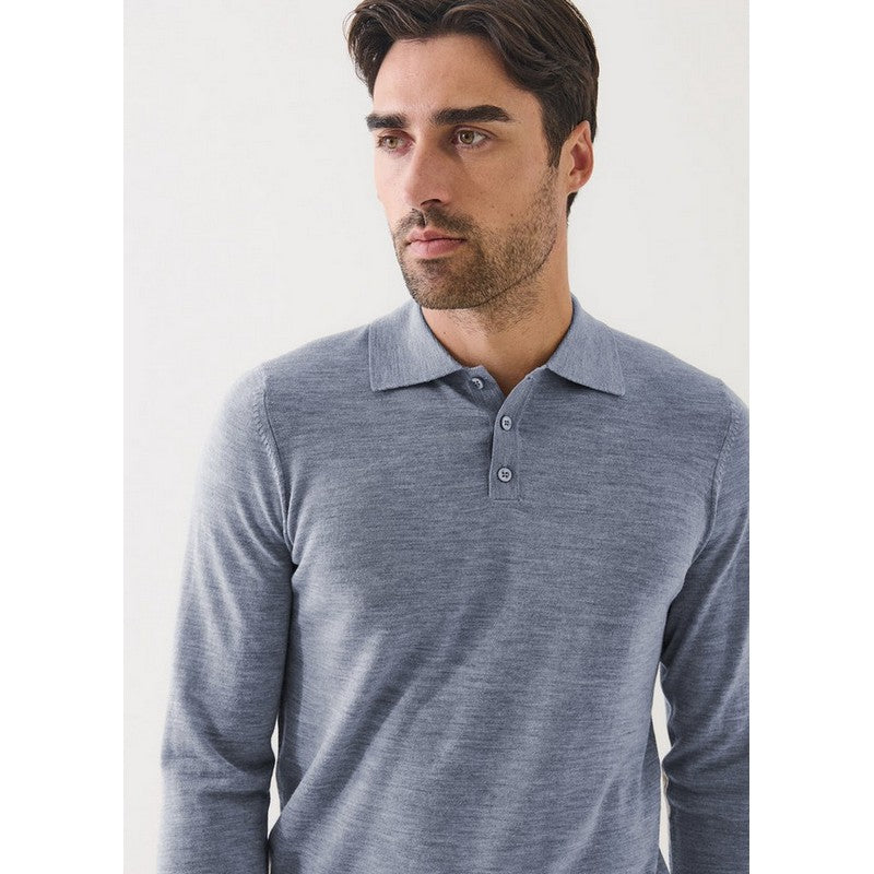 Man wearing a gray long-sleeve polo shirt against a white background