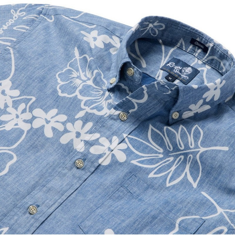 Blue denim shirt with white floral patterns and a brand label on a white background
