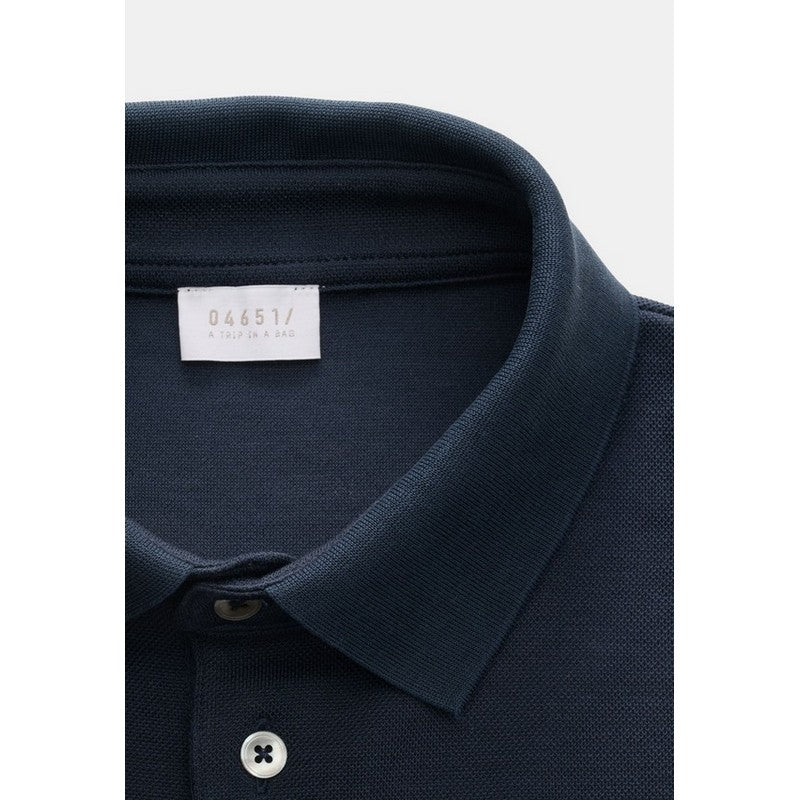 Navy blue polo shirt collar with a brand label on a white background