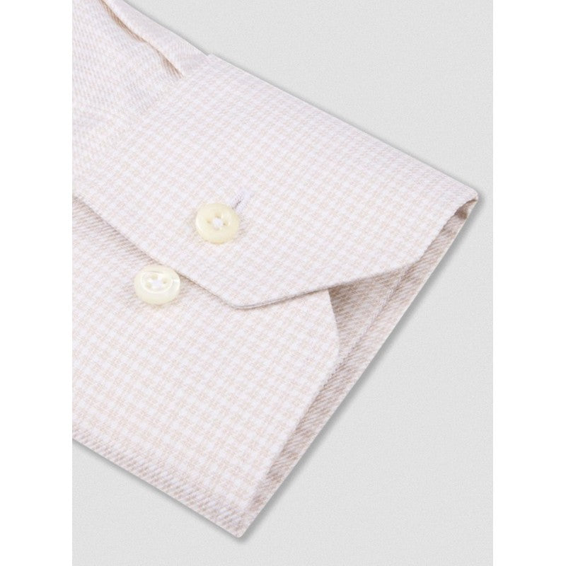 Folded light pink textured fabric with pearl buttons on a white background