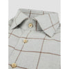 Close-up of a checkered shirt with button details on a white background
