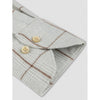 Folded fabric with plaid pattern and buttons on a light gray background