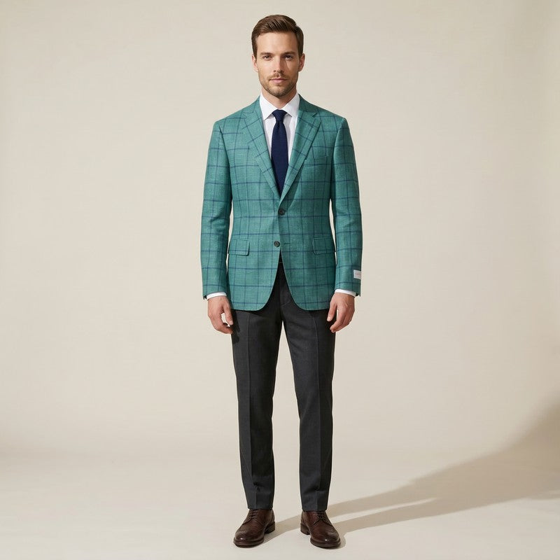 Man wearing a green checkered suit with a white shirt and brown shoes on a beige background