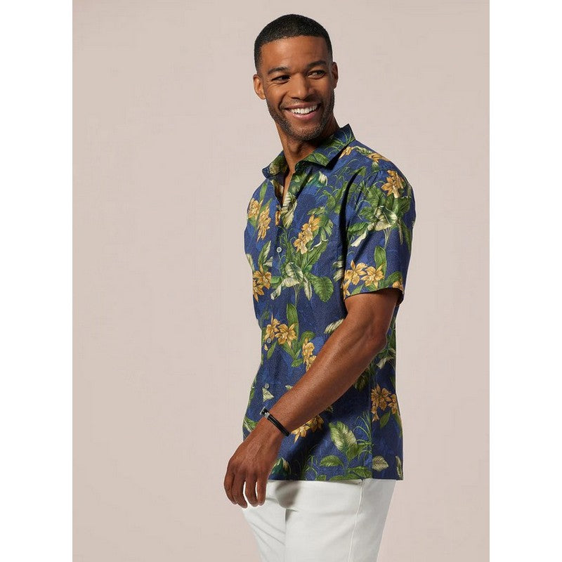 Man wearing a blue floral shirt against a beige background