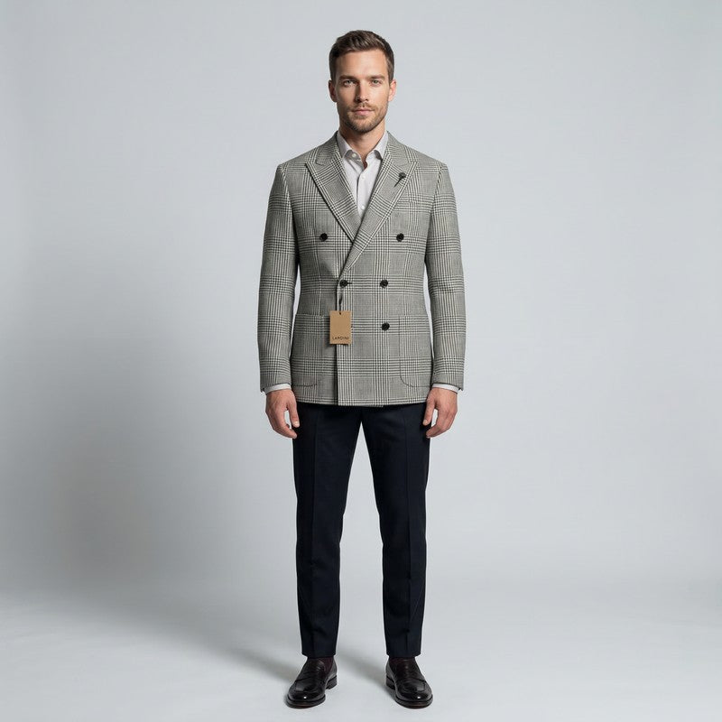 Man wearing a gray checkered blazer with a brown label on a light gray background