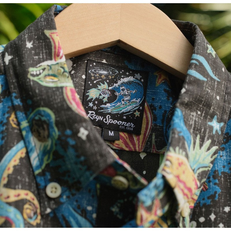 Colorful shirt with dragon design and 'Ray Spooner' label on a hanger