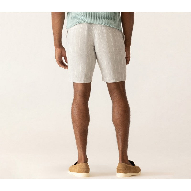Person wearing light-colored shorts on a plain background