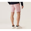 Person wearing pink shorts and white sneakers on a plain background