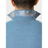 Close-up back view of a person wearing a blue patterned shirt with a light blue paisley inner collar lining, shown against a plain light background.