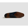 Brown leather shoe sole on a light gray background