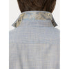 Close-up back view of a man wearing a light blue and white patterned shirt with a decorative gold and silver paisley collar.