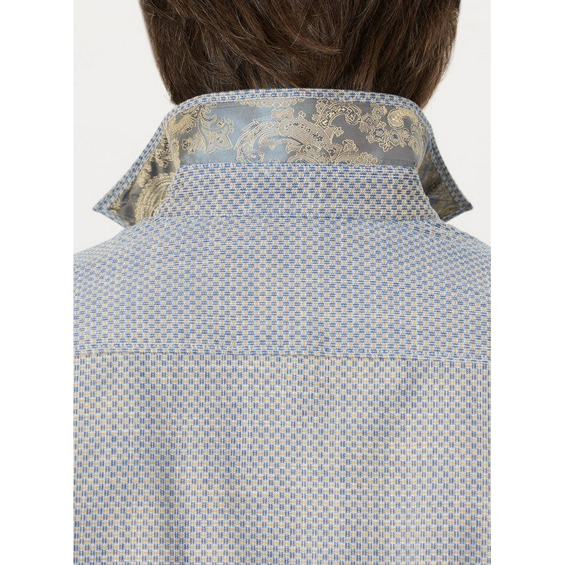 Close-up back view of a man wearing a light blue and white patterned shirt with a decorative gold and silver paisley collar.