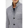 Gray knitted cardigan with black buttons on a white background