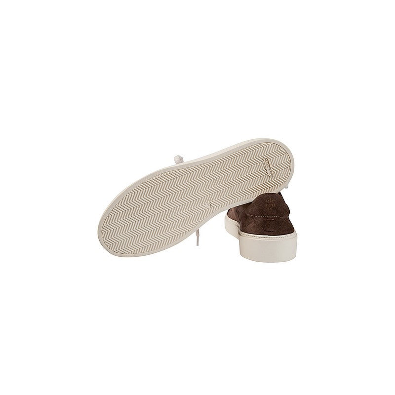 Brown sneaker with a white zigzag pattern on the sole against a white background