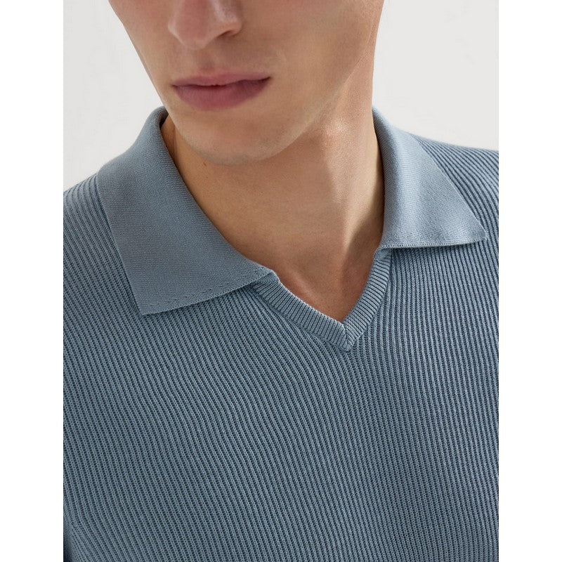 Close-up of a person wearing a light blue ribbed sweater with a collar.