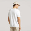 Person wearing a white t-shirt and beige cap on a plain background