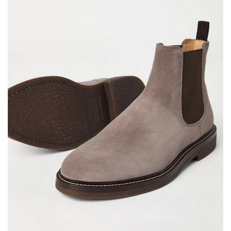 Gray suede Chelsea boots on a white background