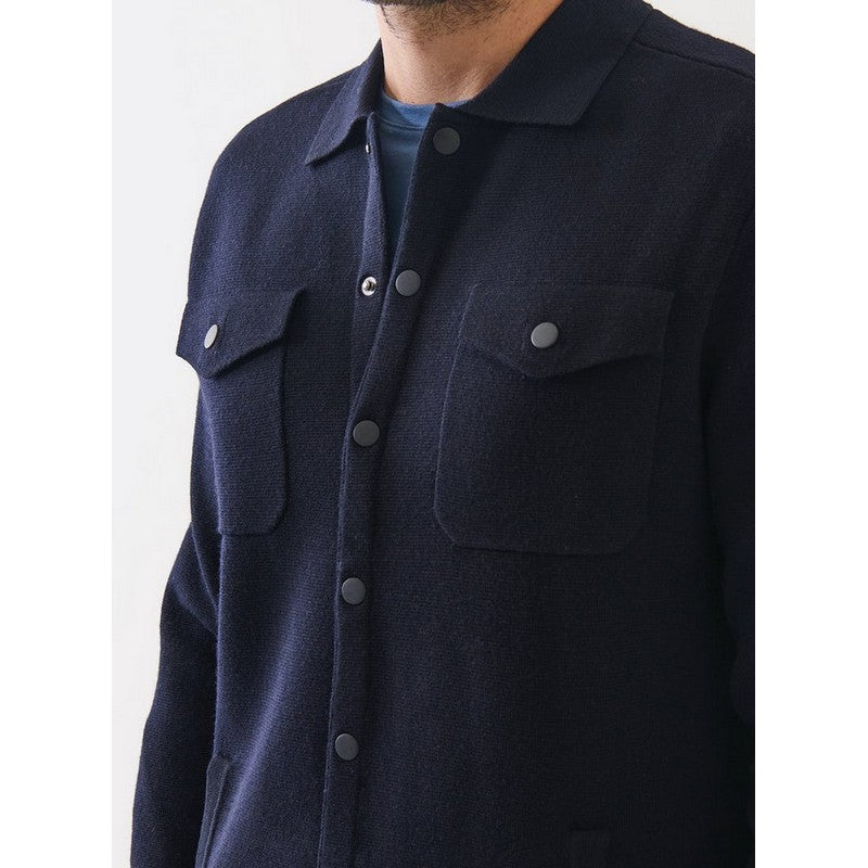 Navy blue shirt with button details on a white background