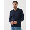 Man wearing a navy long-sleeve polo shirt against a white background