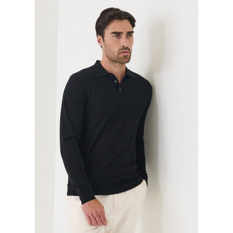 Man wearing a black long-sleeve polo shirt against a white background