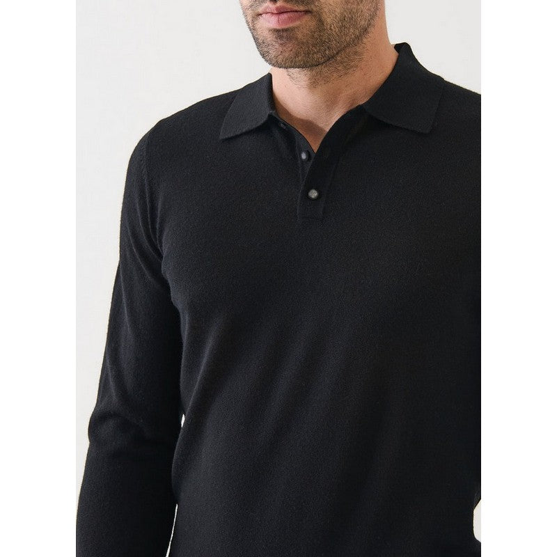 Man wearing a black long-sleeve polo shirt against a white background