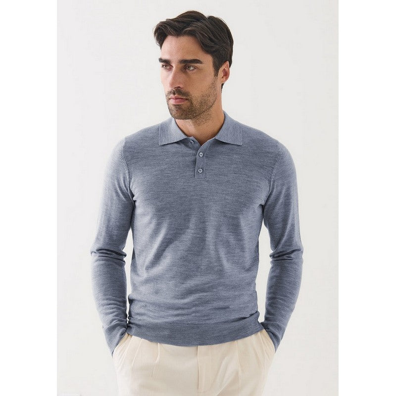 Man wearing a blue long-sleeve polo shirt against a white background