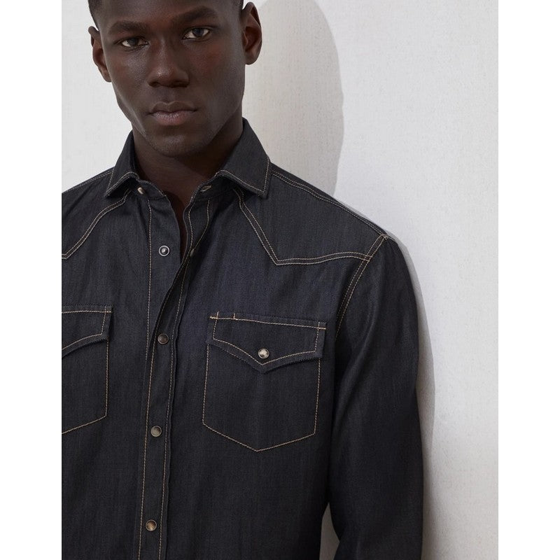 Man wearing a dark denim shirt against a white background