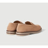 A pair of tan suede penny loafers with brown and beige stacked soles, shown from a three-quarters rear angle on a light gray background.