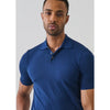 Man wearing a blue polo shirt against a plain background