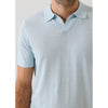 Light blue polo shirt worn by a person on a plain background